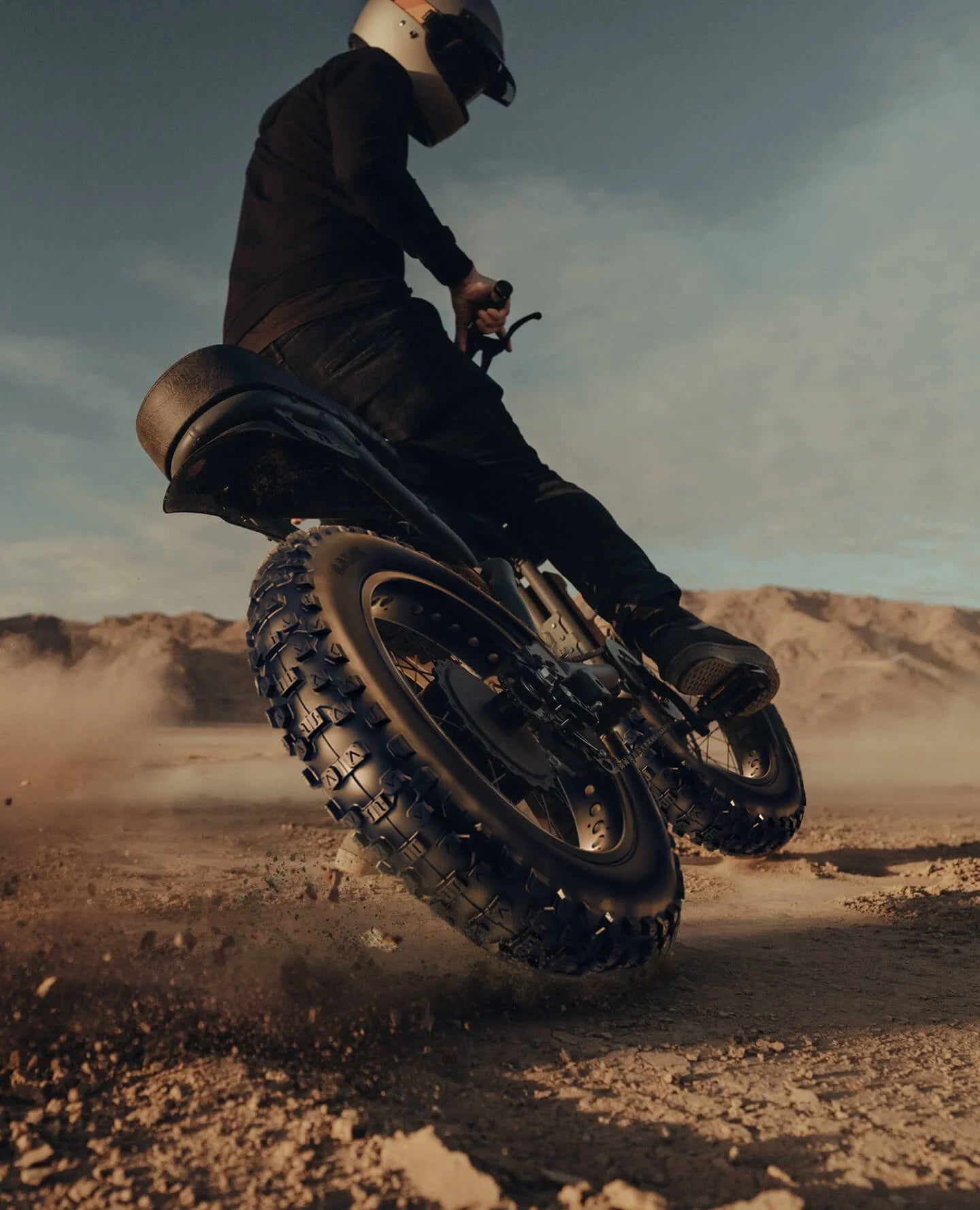 Rider navigating off-road terrain on 20 x 4 Rock Conqueror Heavy Duty Tire, showcasing grip and durability.